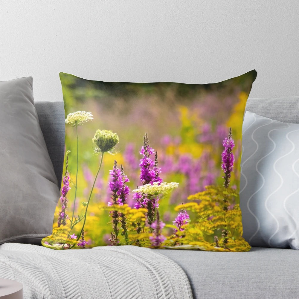 Colorful photograph of a blooming summer meadow printed on a soft, decorative pillow