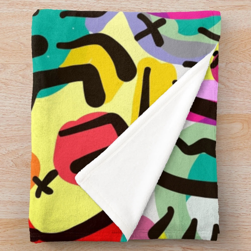 Colorful plush blanket with vibrant pop art patterns by artist Emmanuel Signorino