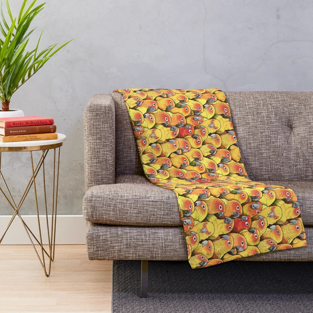 Plush blanket featuring a colorful sun conure parrot design