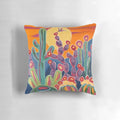 A vibrant sunset-inspired pillow featuring hummingbirds, cacti, and blooming flowers in a southwestern style.