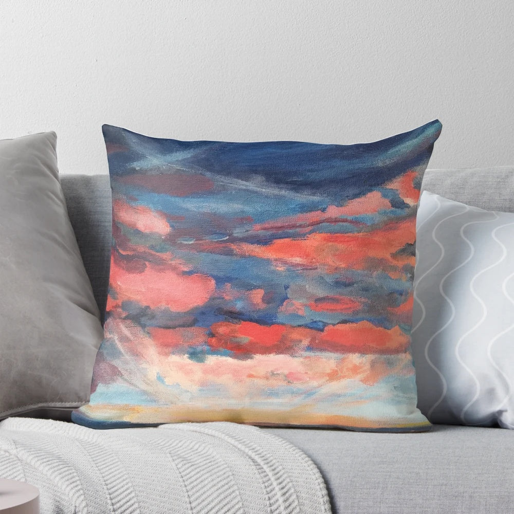 A beautiful throw pillow featuring a vibrant sunset seascape design with indigo, coral, and navy accents.