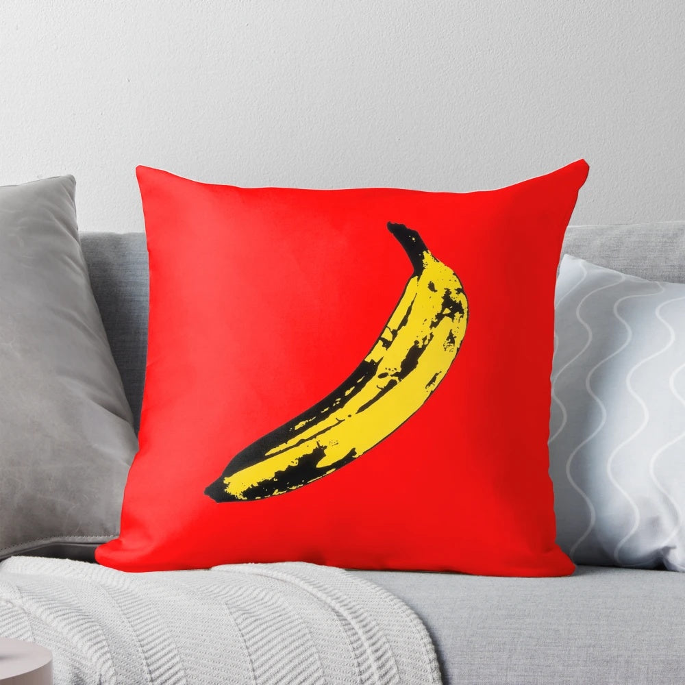 A vibrant and surreal big yellow banana decorative throw pillow featuring graphic design and vector art elements.