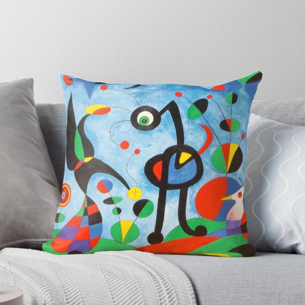 Colorful surrealist art pillow featuring the abstract designs of renowned Spanish artist Joan Miró