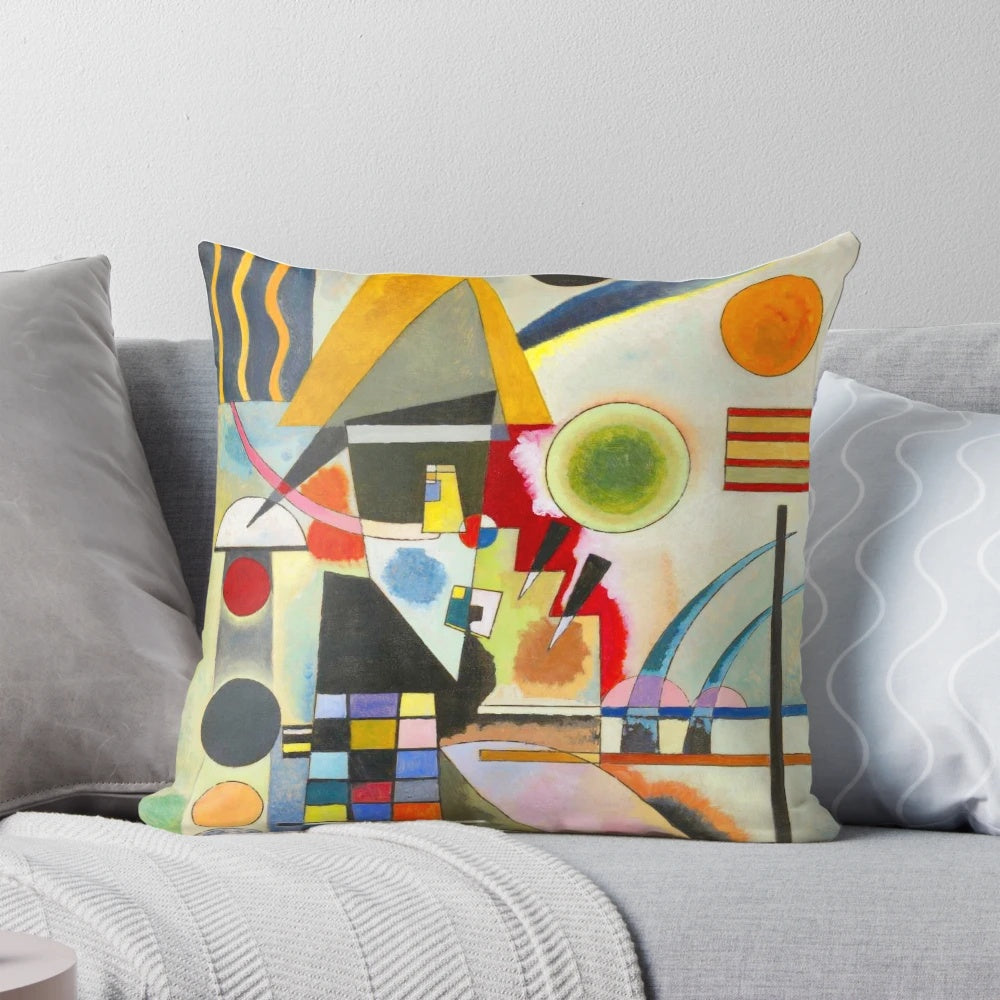 A colorful, abstract swinging pillow featuring geometric shapes and patterns in the style of Russian artist Wassily Kandinsky.