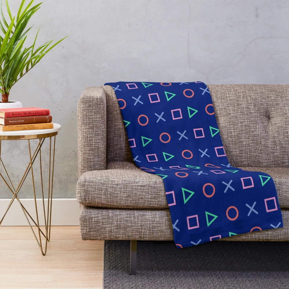 Blue and pink synthwave-inspired plush blanket with Playstation controller buttons design