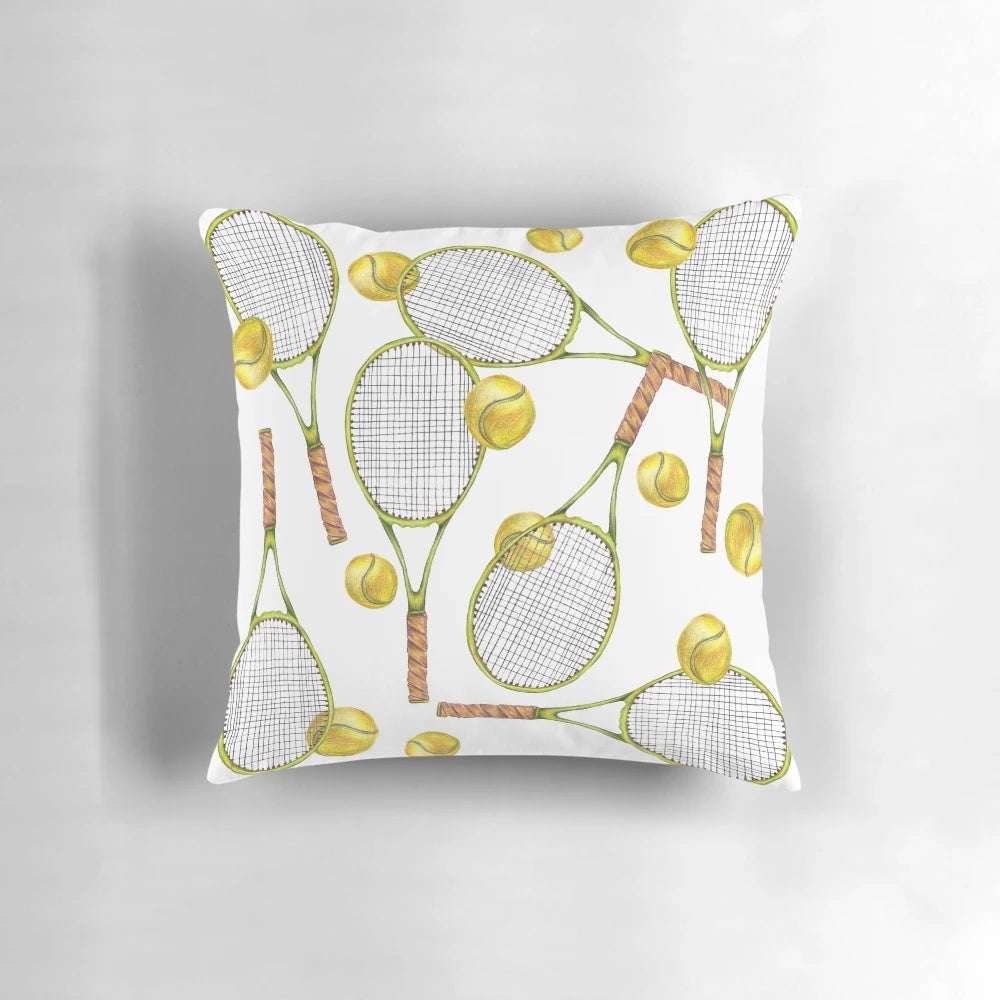Colorful throw pillow with a pattern of tennis rackets and balls, ideal for sports-themed home decor