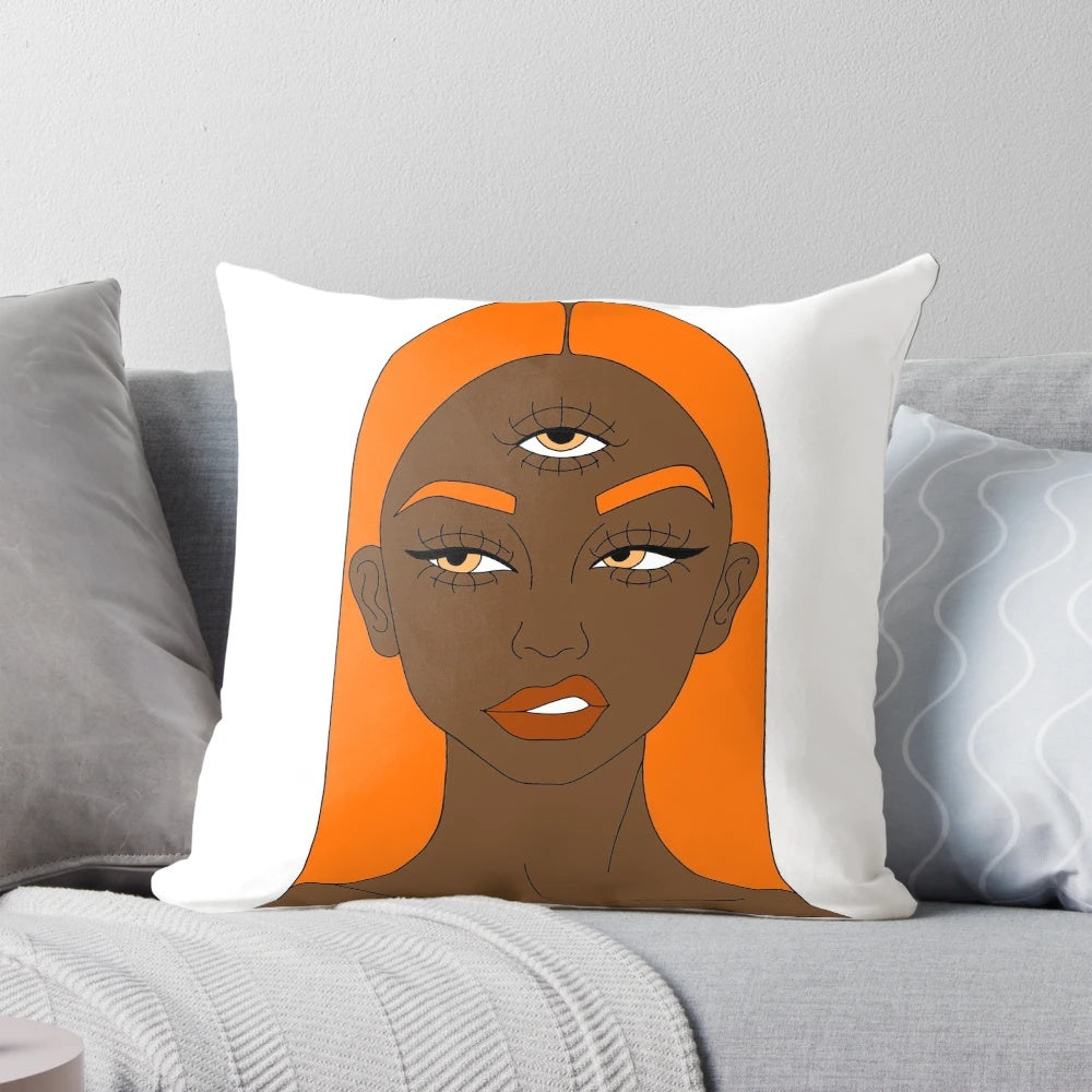 Vibrant orange and black digital art illustration of a girl with a third eye, featured on a plush pillow.