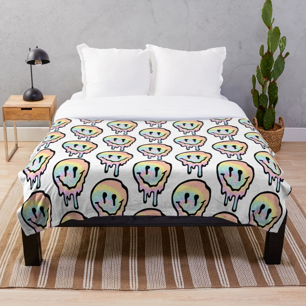 Colorful tie dye plush blanket with a drippy smiley face design