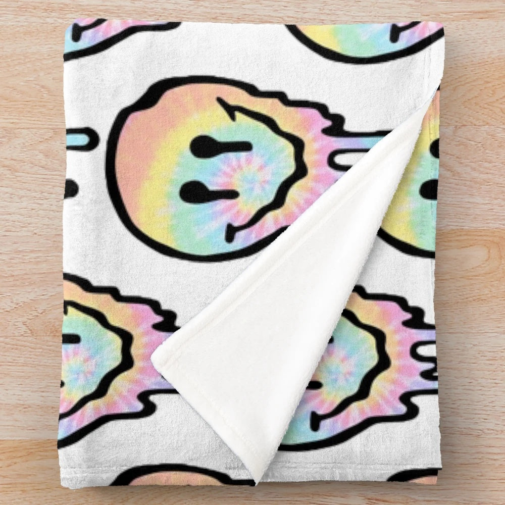 Colorful tie dye plush blanket with a drippy smiley face design