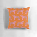 Closeup of a pink and orange pillow with a repeating tiger pattern, perfect for adding a touch of whimsy to any room.