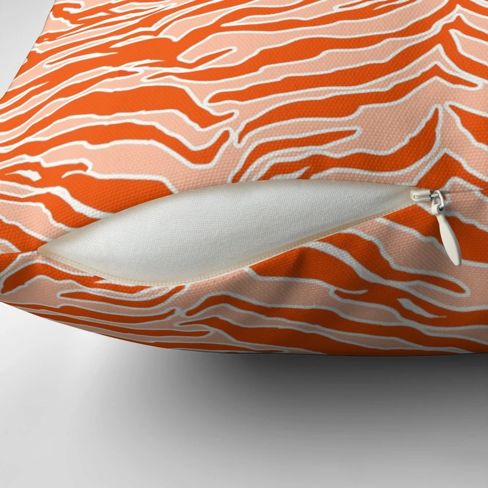Closeup of an orange and black tiger print pillow