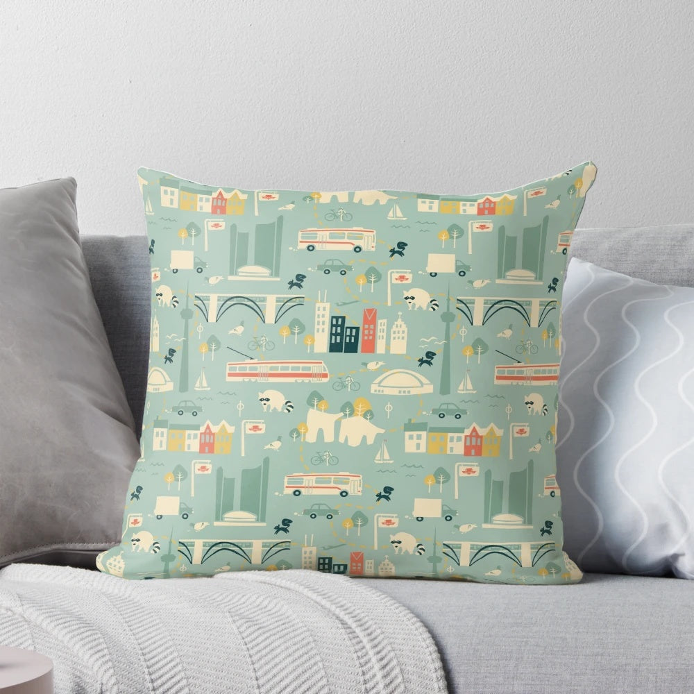 Decorative square pillow featuring a vibrant cityscape of Toronto's iconic buildings, buses, and streetcars.