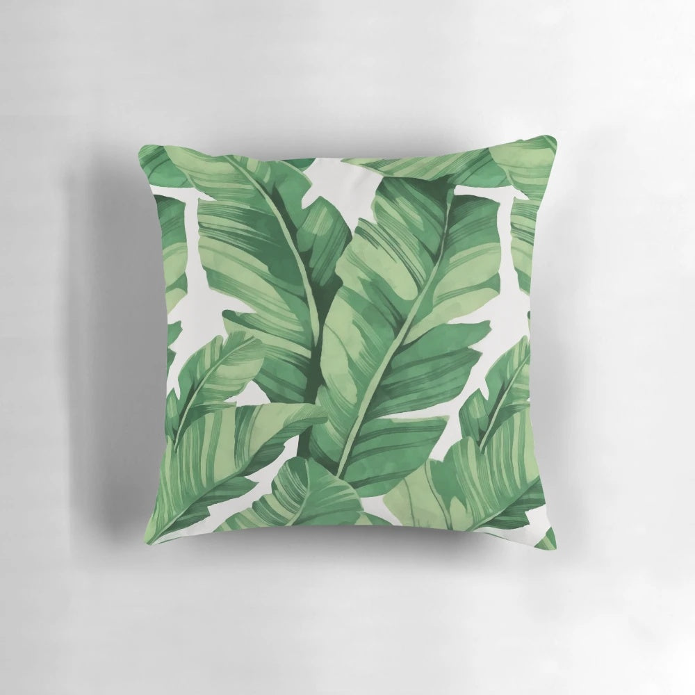 A vibrant, tropical-inspired pillow featuring a pattern of banana leaves.