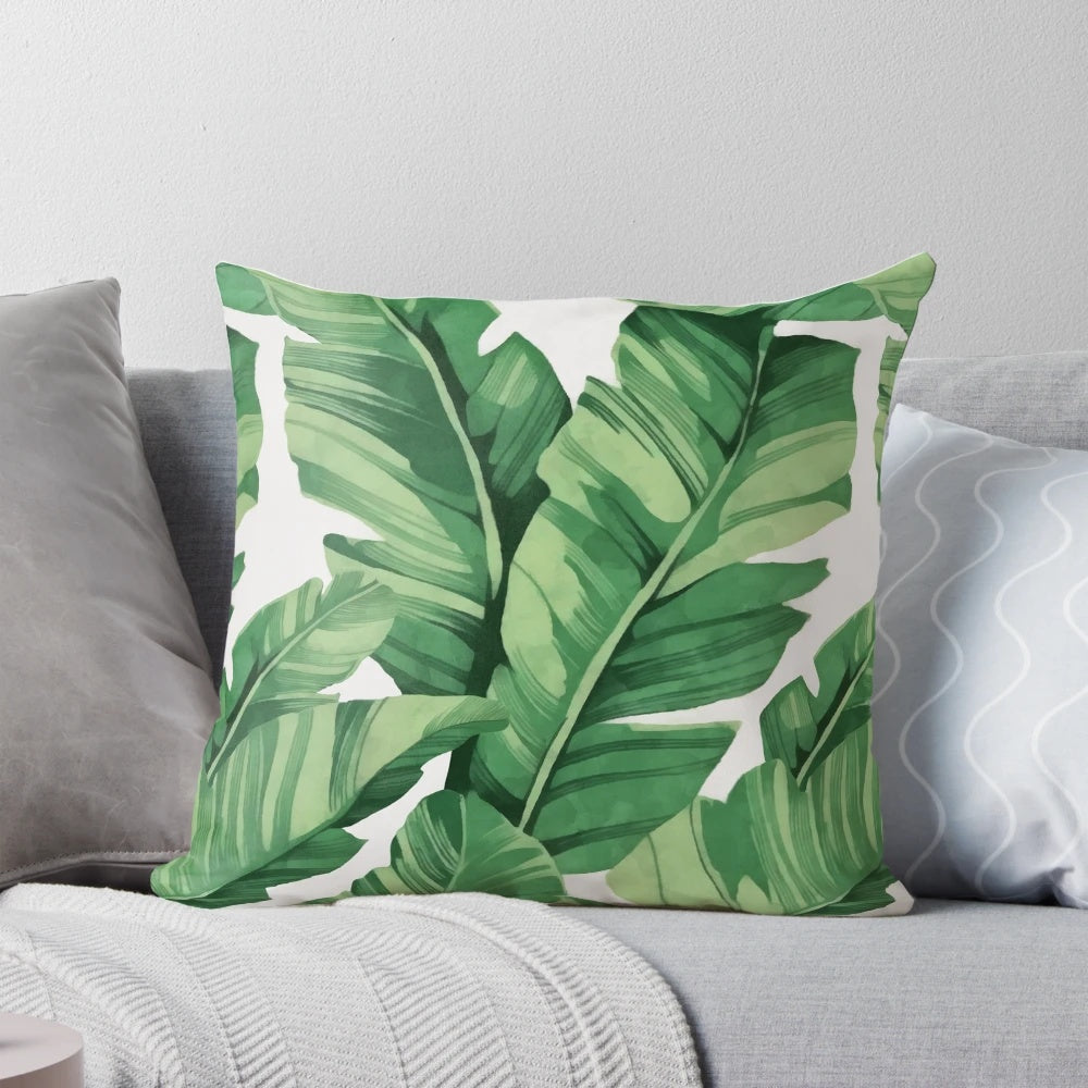 A vibrant, tropical-inspired pillow featuring a pattern of banana leaves.