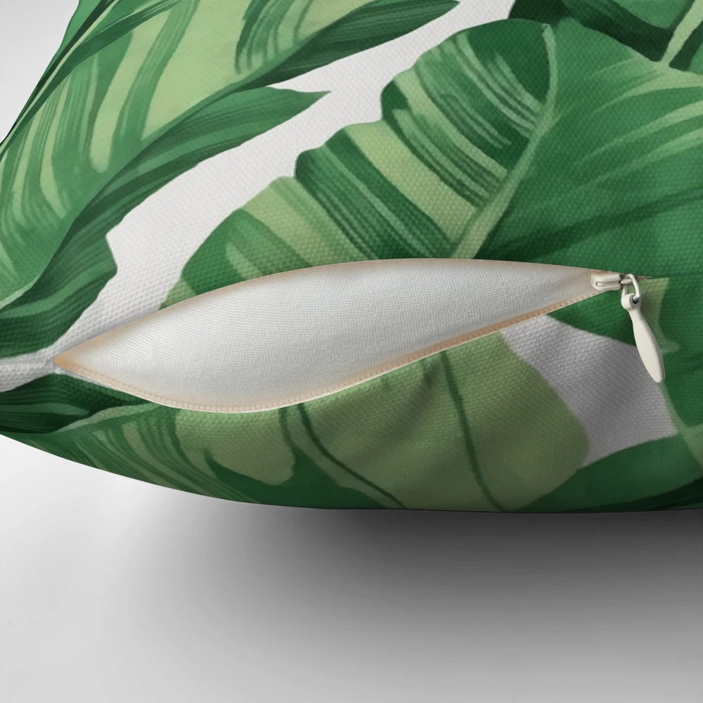 A vibrant, tropical-inspired pillow featuring a pattern of banana leaves.