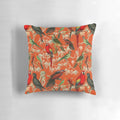 Vibrant orange and botanical patterned pillow featuring tropical birds
