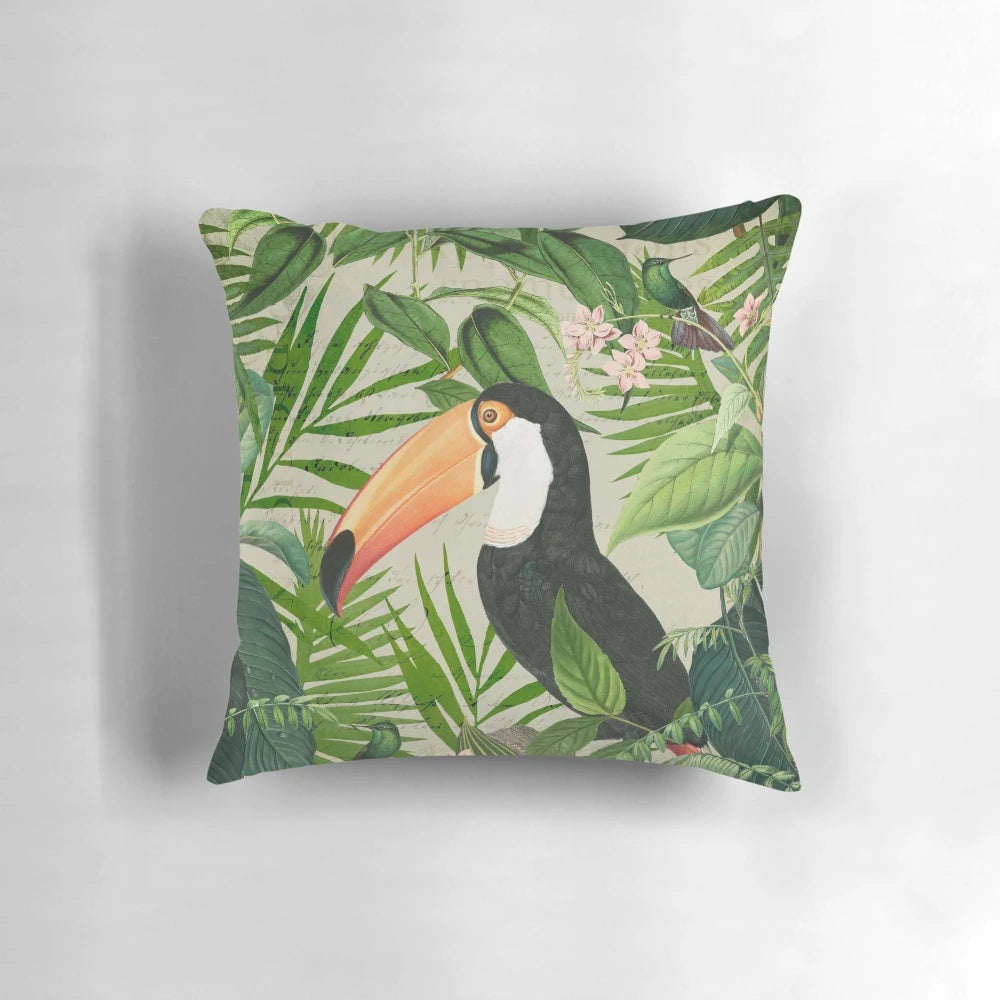 Decorative pillow featuring a vibrant print of a toucan and hummingbird in a lush, tropical setting.