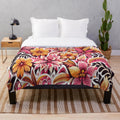 Tropical Flame Garden Plush Blanket featuring vibrant floral and botanical motifs
