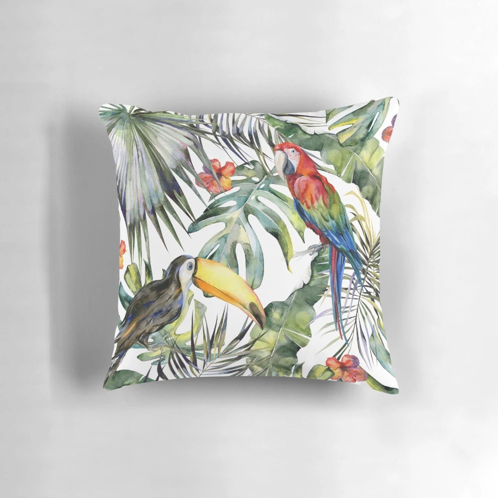 A vibrant throw pillow featuring a tropical jungle scene with watercolor birds, leaves, and flowers.