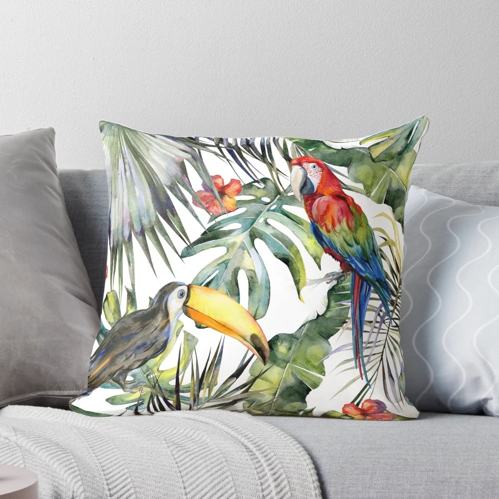 A vibrant throw pillow featuring a tropical jungle scene with watercolor birds, leaves, and flowers.
