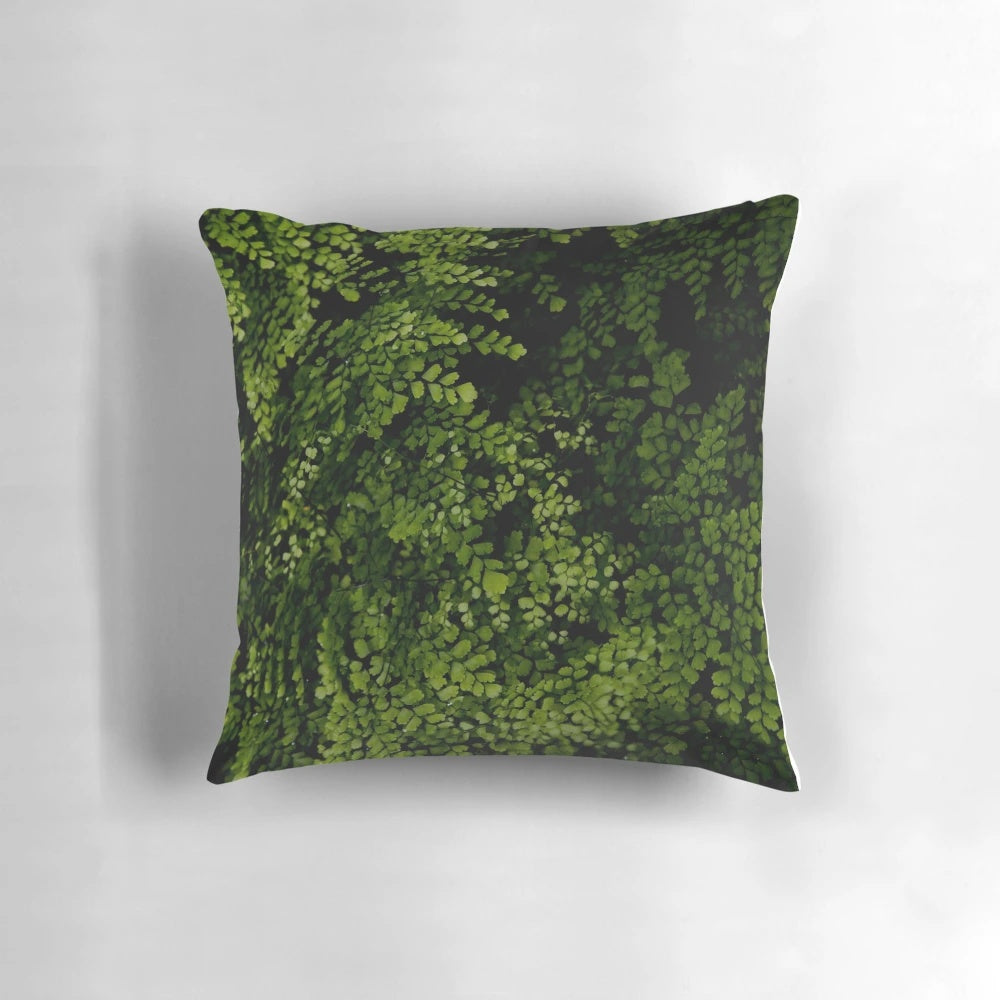 Closeup of small, green tropical leaves on a decorative pillow
