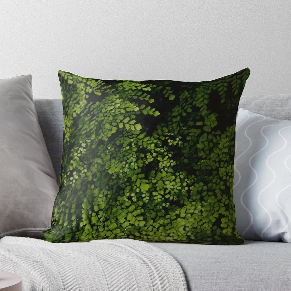 Closeup of small, green tropical leaves on a decorative pillow