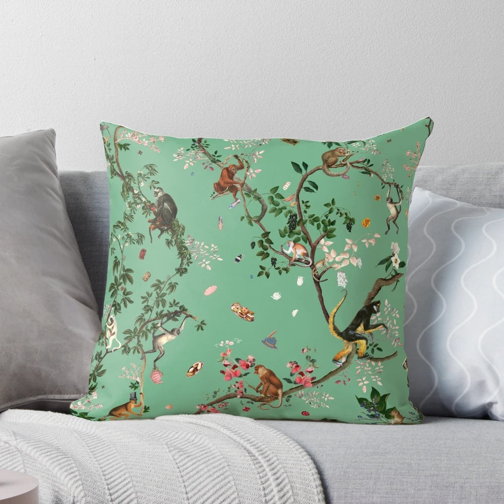 A lush, green pillow featuring a playful monkey design amidst a botanical, floral jungle pattern.