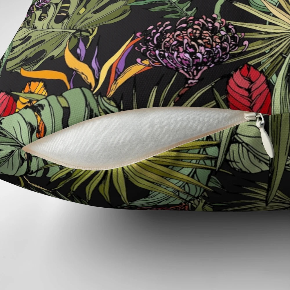 Tropical pattern black pillow with strelitzia, monstera, and palm leaf print