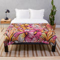 Tropical plush blanket with vibrant floral and polynesian art patterns