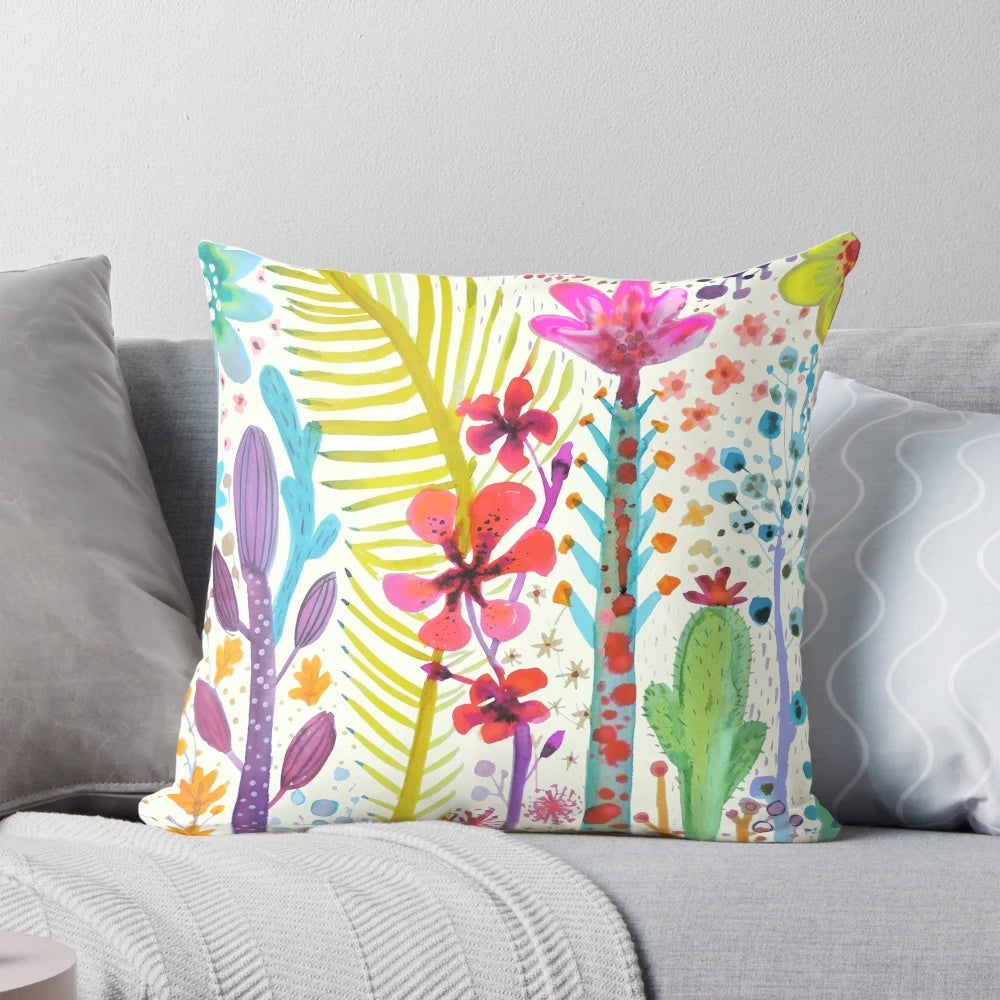 Colorful watercolor floral design on a tropical throw pillow with cactus and botanical elements