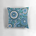 Colorful turquoise blue patterned throw pillow with Australian aboriginal-inspired design