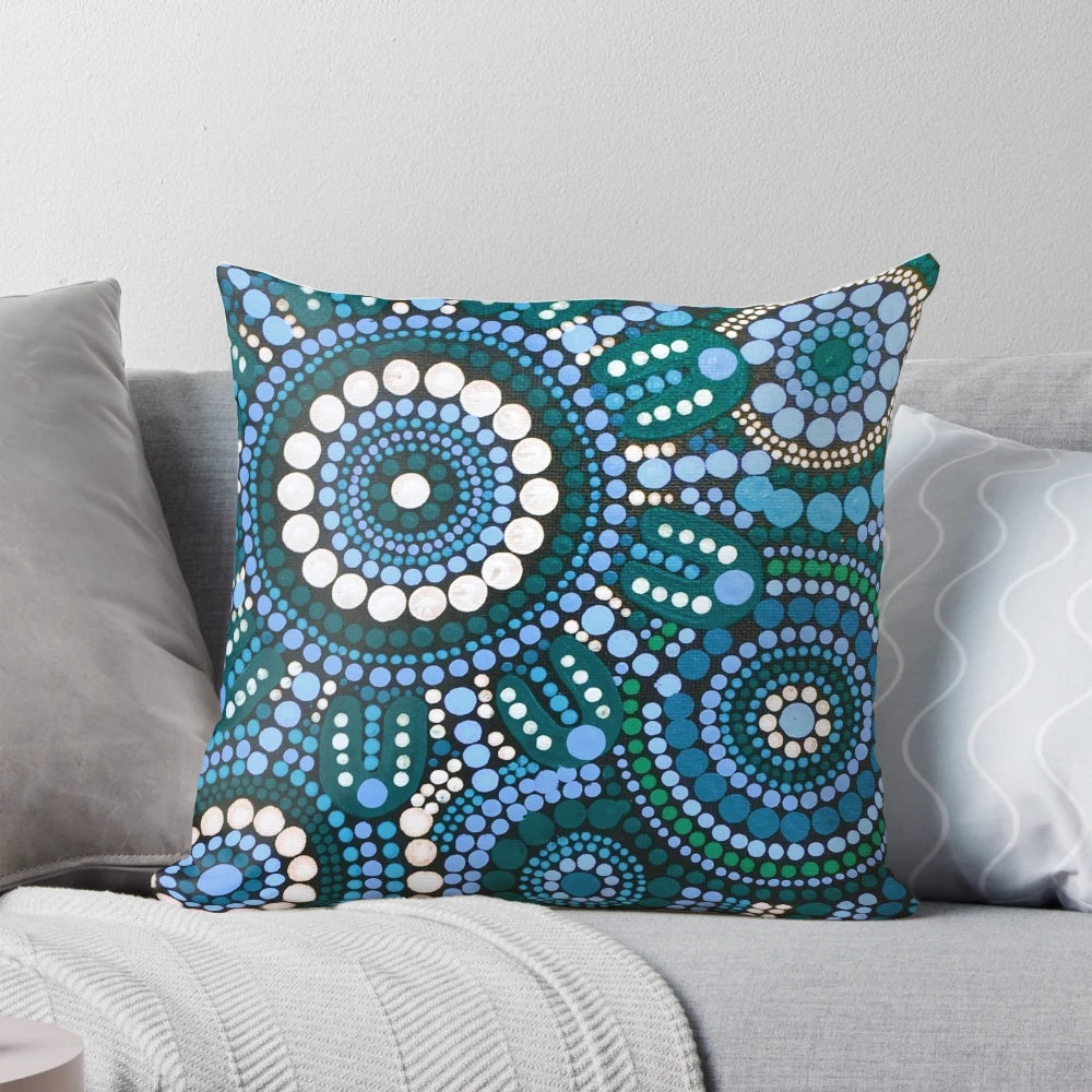 Colorful turquoise blue patterned throw pillow with Australian aboriginal-inspired design