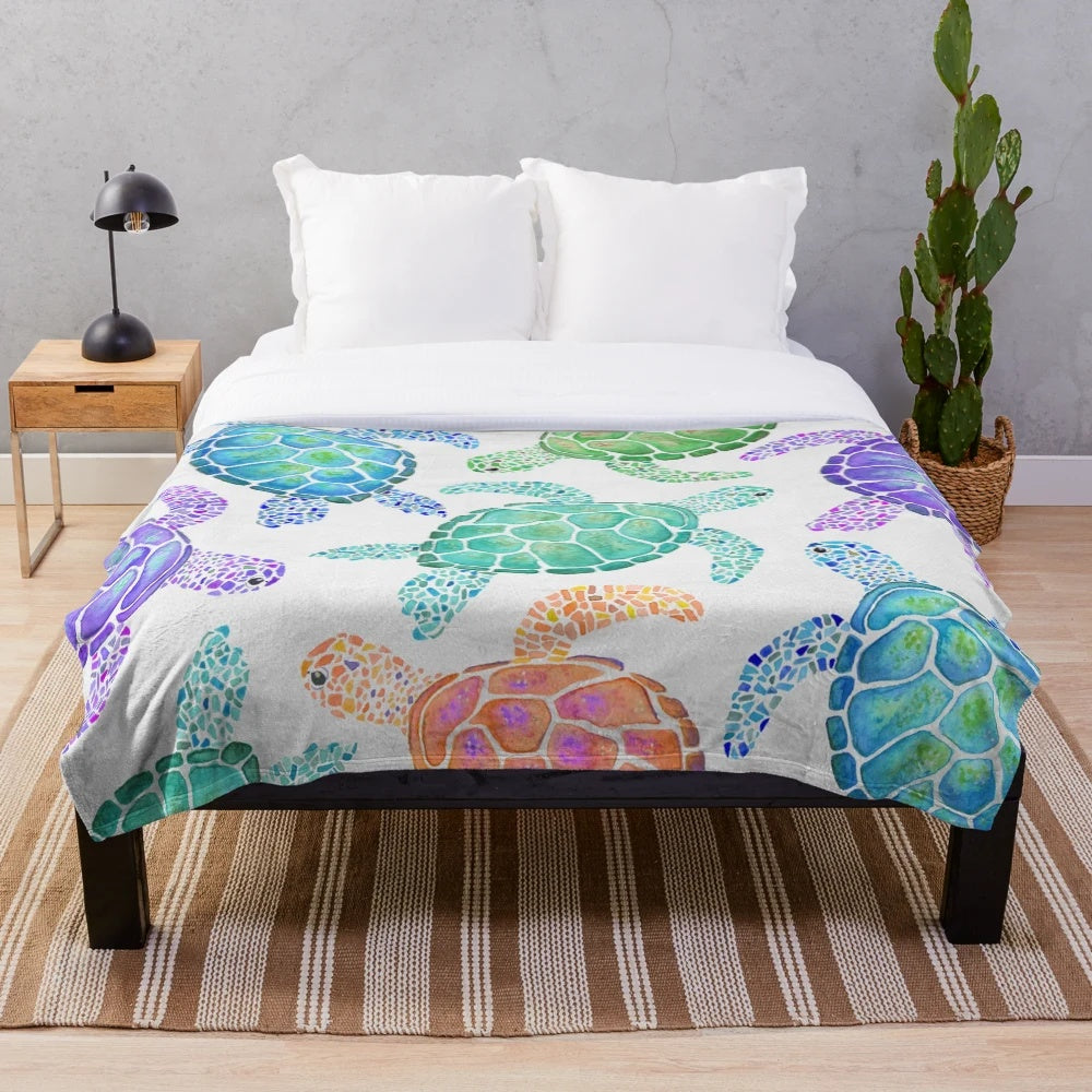 Colorful watercolor-style turtle pattern on a soft, plush blanket for cozy home decor