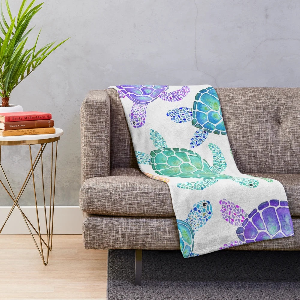 Colorful watercolor-style turtle pattern on a soft, plush blanket for cozy home decor