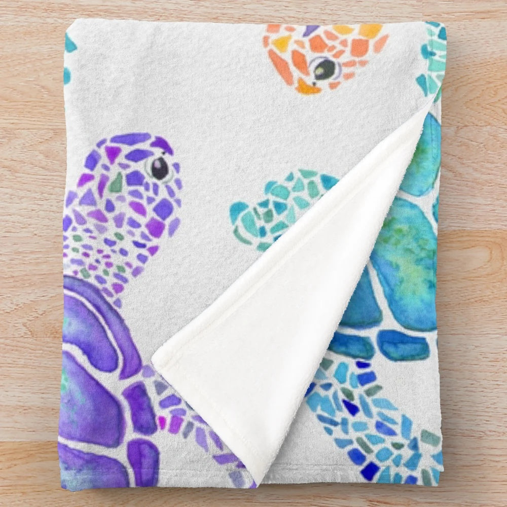Colorful watercolor-style turtle pattern on a soft, plush blanket for cozy home decor