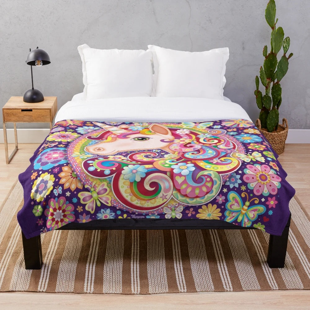 Colorful unicorn inspired plush blanket with rainbow, flowers, and butterflies