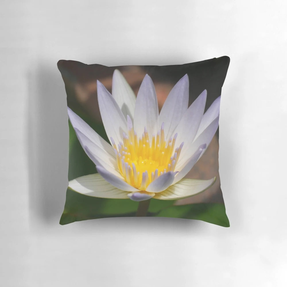 A colorful and artistic water lily flower printed on a decorative throw pillow.