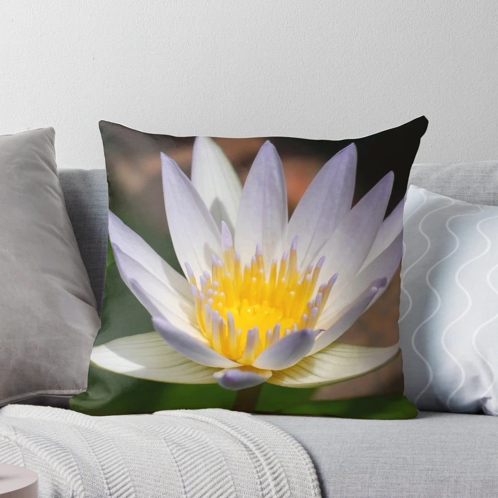 A colorful and artistic water lily flower printed on a decorative throw pillow.