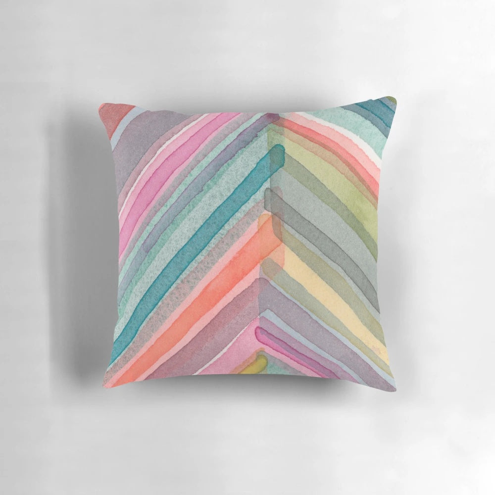 A colorful, bold, and modern watercolor abstract geometric chevron pattern pillow.