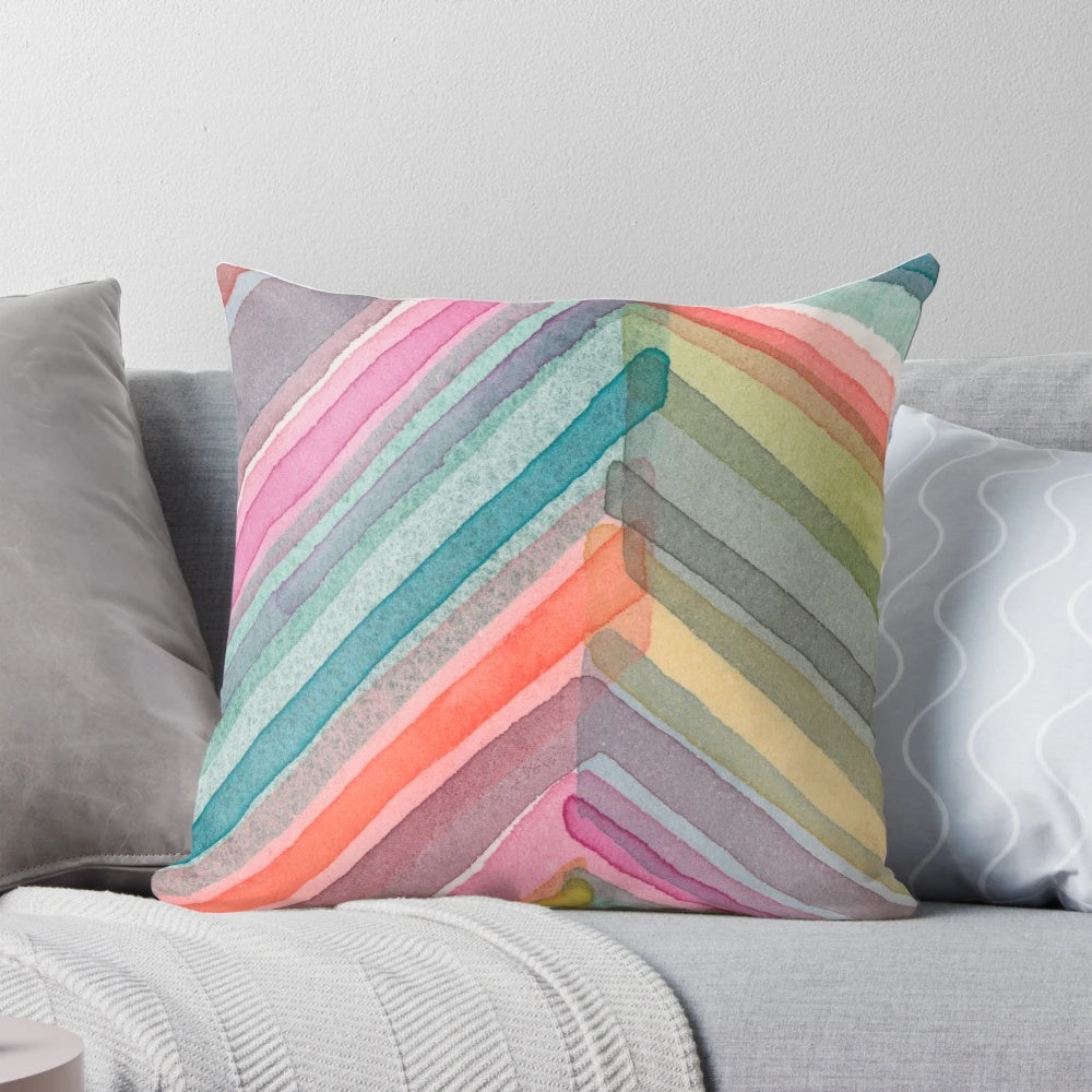 A colorful, bold, and modern watercolor abstract geometric chevron pattern pillow.