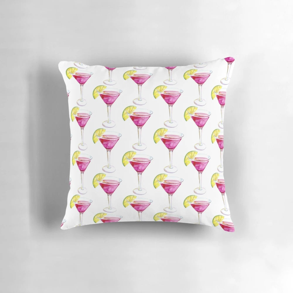 Colorful watercolor painting of a cosmopolitan cocktail on a decorative throw pillow