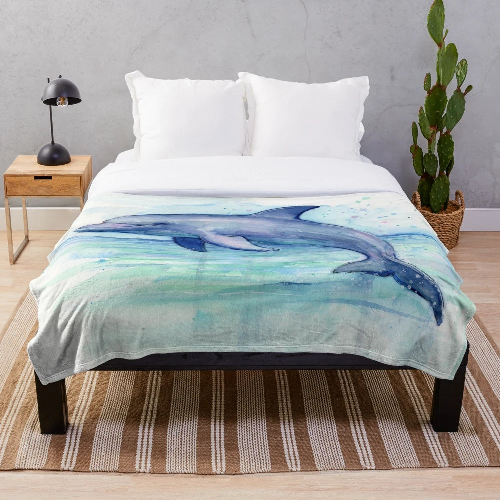 Colorful watercolor dolphin illustration on a plush blanket