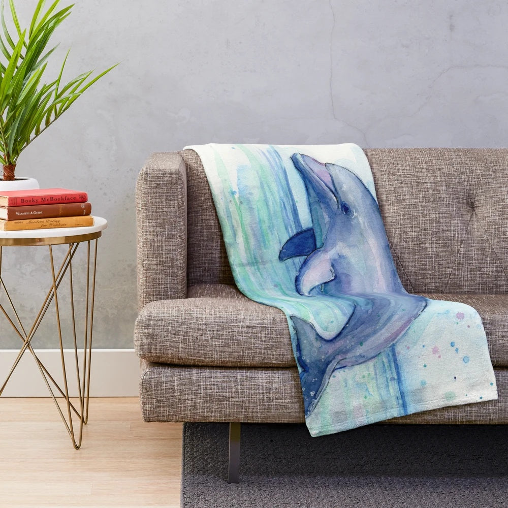 Colorful watercolor dolphin illustration on a plush blanket