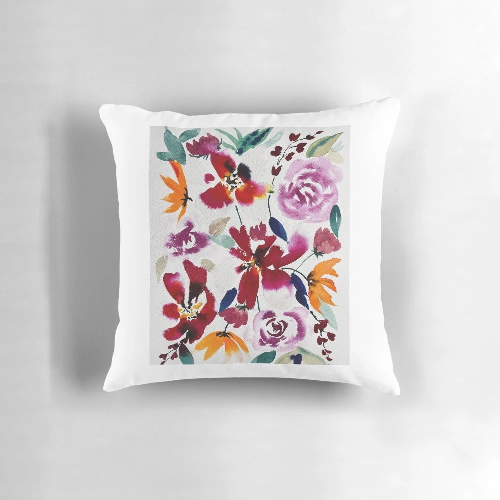 Bright and bold watercolor floral pattern on a lush, decorative pillow.