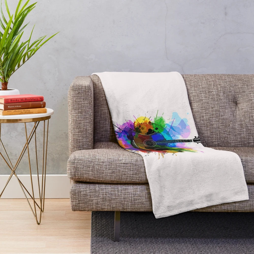 Colorful watercolor guitar design on a plush blanket