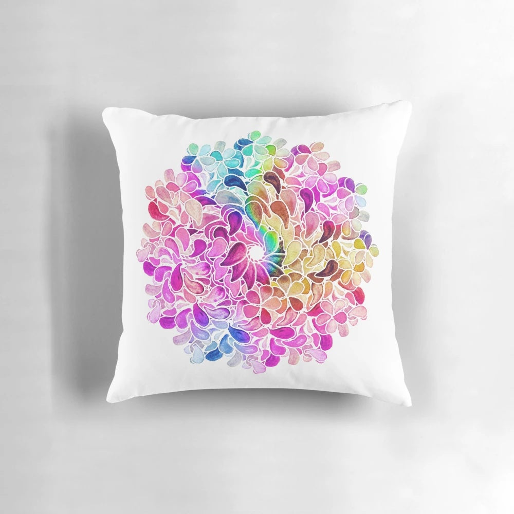 A vibrant, colorful throw pillow featuring a watercolor paisley floral design in shades of purple, blue, and pink.