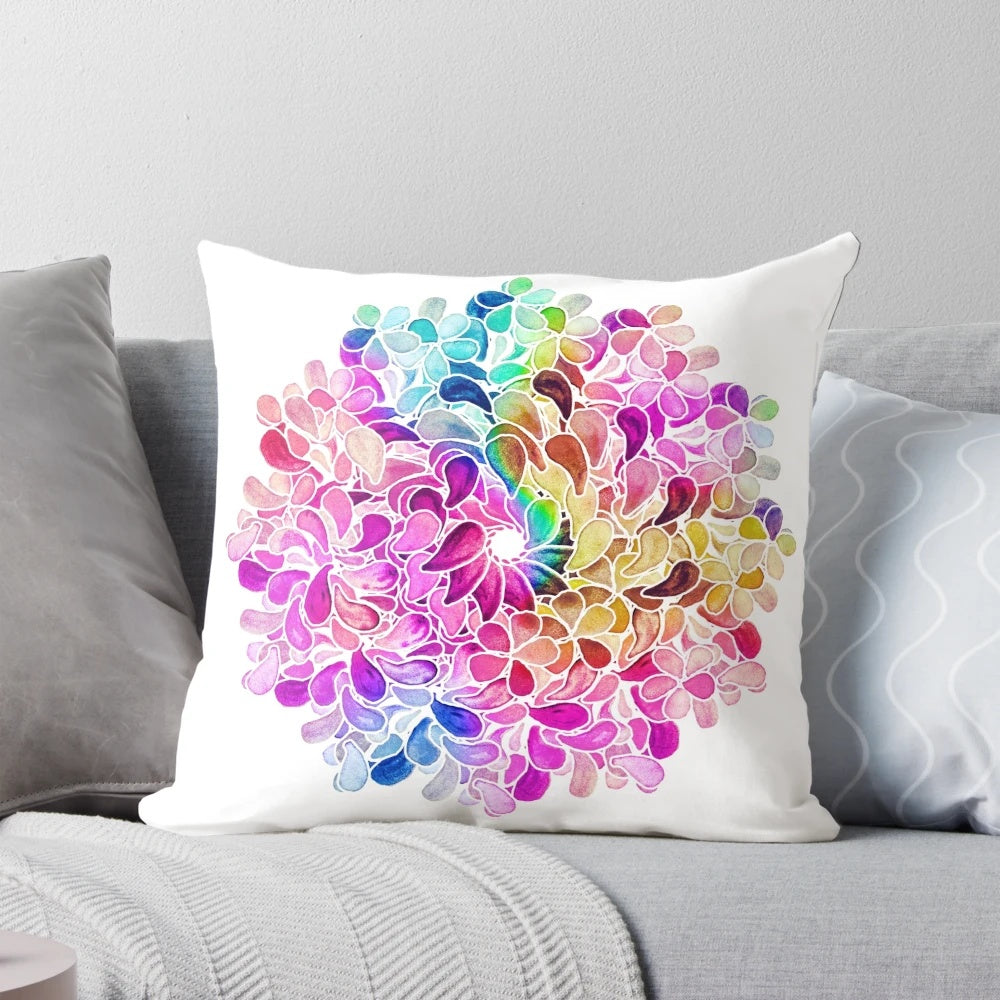 A vibrant, colorful throw pillow featuring a watercolor paisley floral design in shades of purple, blue, and pink.