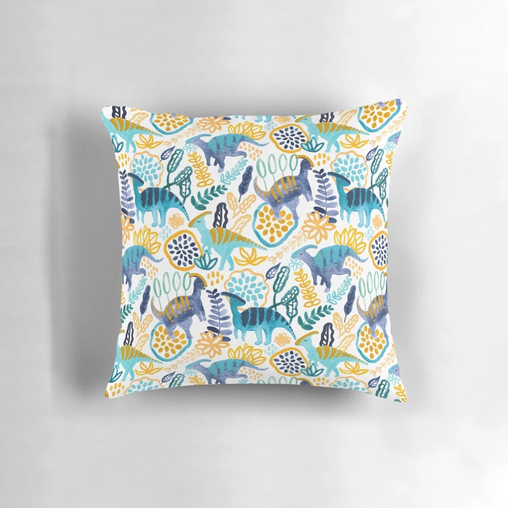 A vibrant watercolor and gouache painting of a parasaurolophus dinosaur on a plush pillow.