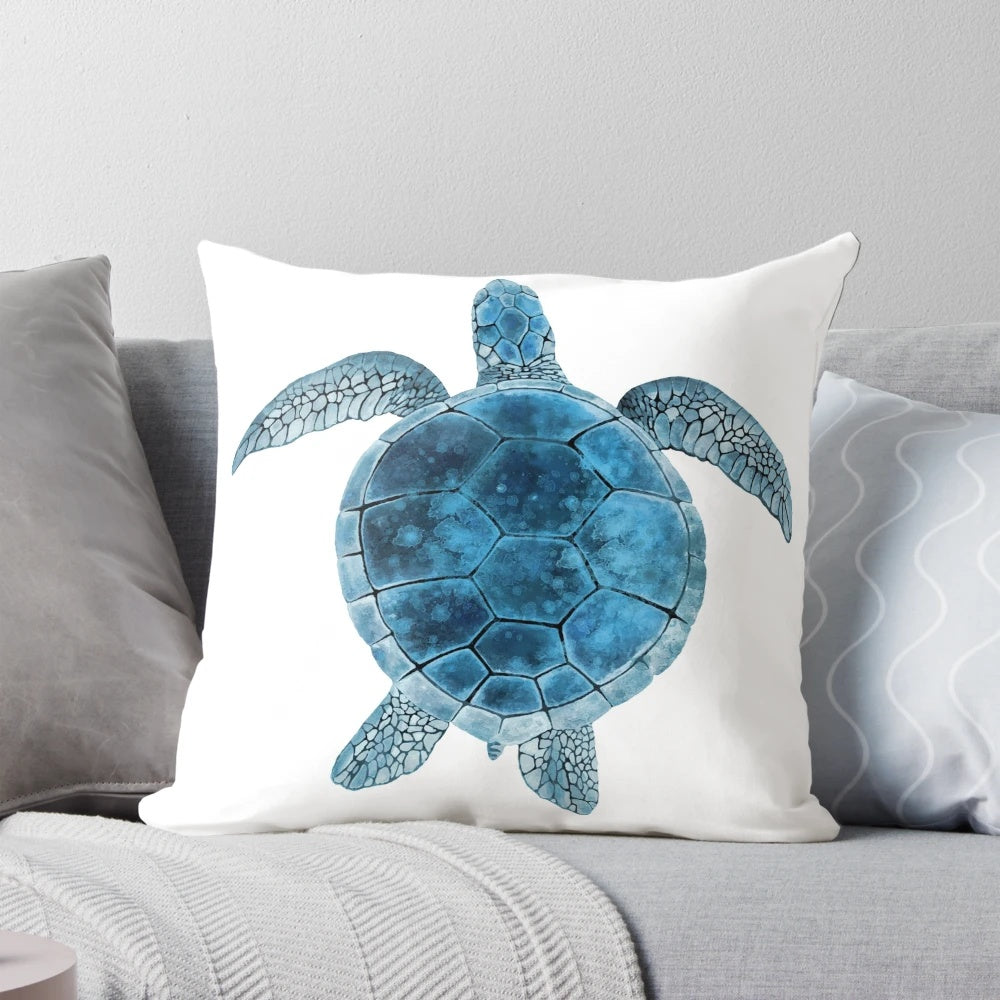 Closeup of a vibrant watercolor painting of a sea turtle in shades of turquoise and blue on a decorative throw pillow