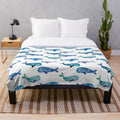 Soft, cozy plush blanket featuring vibrant watercolor whales